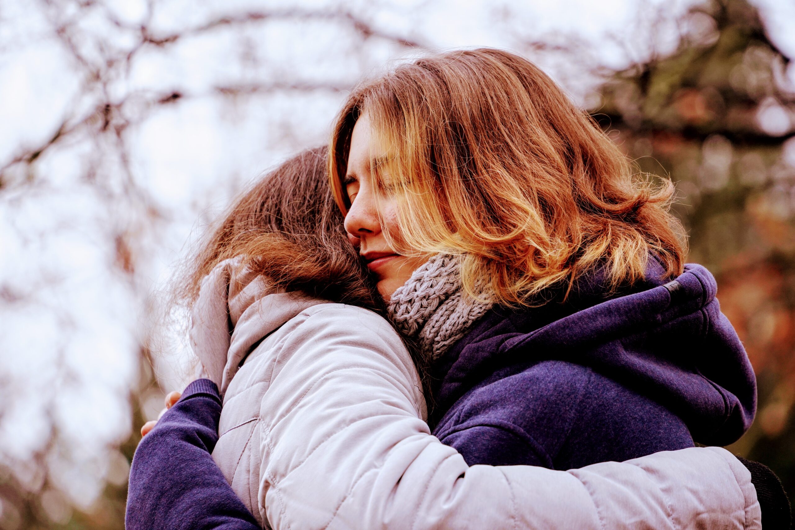 two people hug in the park